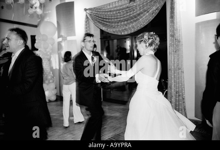 Poland, Lodz, bride and groom dancing in wedding party (B&W) Stock Photo