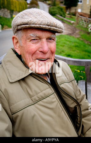 Jim Fern, known as Little Jim in Cider with Rosie by Laurie Lee sitting on a bench in Slad, Gloucestershire Stock Photo