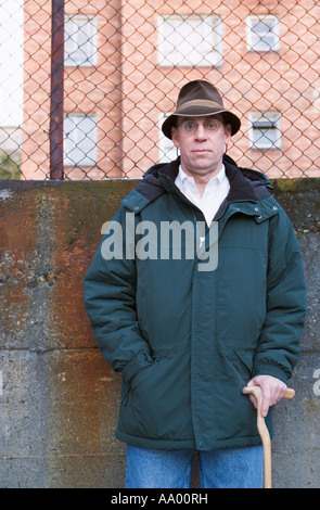 Portrait of man wearing hat and using walking cane Stock Photo