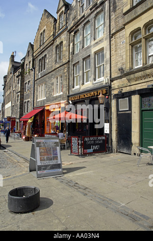 A view along the north side of Grassmarket in the old town of Edinburgh showing a pub and shops Stock Photo