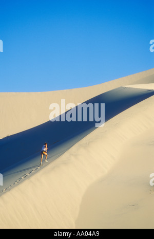 Man running on sand dunes in Death Valley California USA model released image Stock Photo