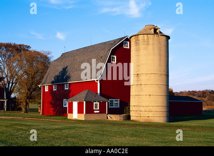 Agriculture - Red barn and silo in Autumn with green lawn in the foreground / Waterford, Wisconsin, USA. Stock Photo