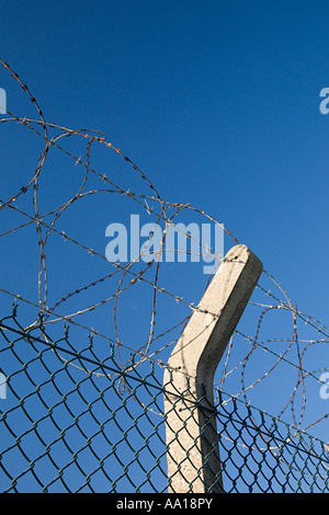 Barbed and razor wire on a fence Stock Photo