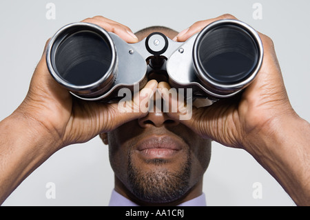 Man looking through binoculars Stock Photo