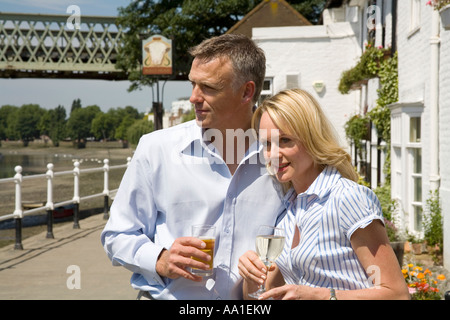 Couple at Strand on the Green outside the Bulls Head Pub Chiswick London Stock Photo