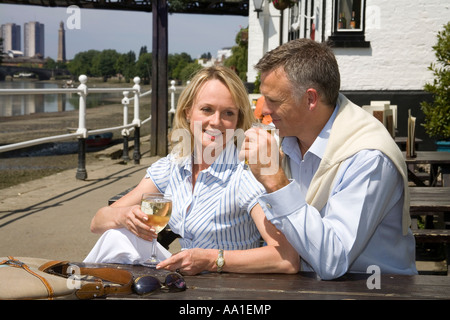 Couple at Strand on the Green outside the Bulls Head Pub Chiswick London Stock Photo