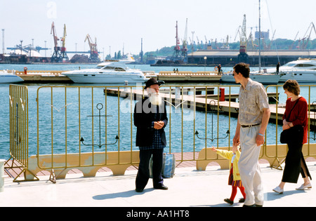 Ukraine, Odessa, people walking on marina, side view Stock Photo