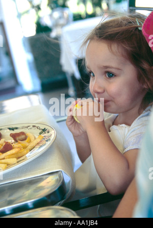 Young girl puckering up her lips after sucking a lemon Stock Photo