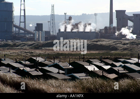 Green sheds and the Corus steel works at the river Tees Cleveland UK Stock Photo