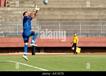 Goalkeeper Makes a Save at a Football Match Stock Photo