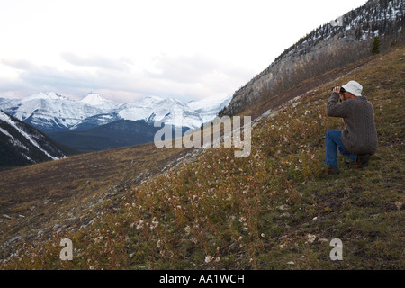 Man with Binoculars in Foothills Stock Photo