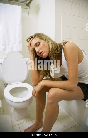 Sick Woman in Bathroom Stock Photo