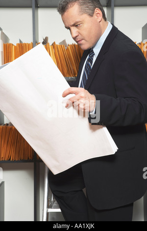 Businessman Looking at Records Stock Photo