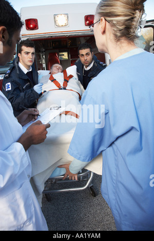 Paramedics and Doctors with Patient on Stretcher
