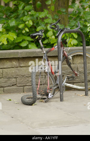 Pushbike cycle with buckled wheel damage vandalised vandal flat tire broken bike push Stock Photo