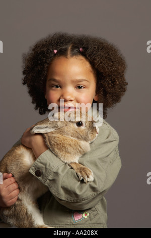 Portrait of Girl Holding Rabbit Stock Photo