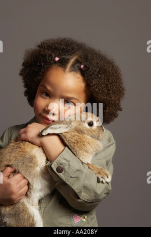 Portrait of Girl Holding Rabbit Stock Photo