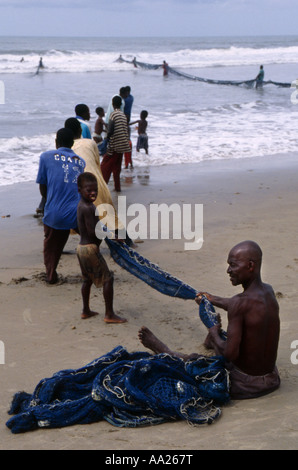 Bringing in large fishing nets from the sea at Kokrobite, a small fishing village near Accra, Ghana Stock Photo