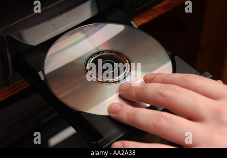 Person Putting CD Into CD Player Stock Photo