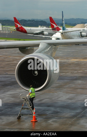 An flight engineer inspects the engine of a Boeing 747 Jet aircraft at Auckland International Airport Stock Photo