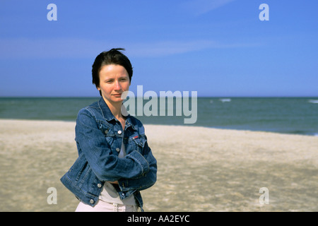Denmark, woman standing on beach, portrait Stock Photo