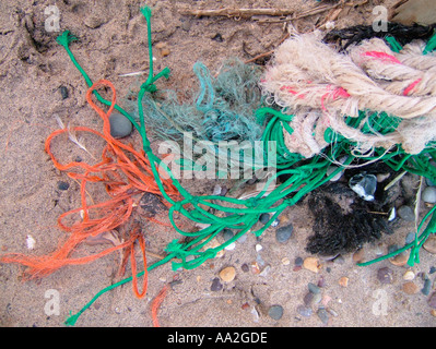 Discarded plastic ropes and nets, known as ghost fishing gear, washed up on a UK beach Stock Photo