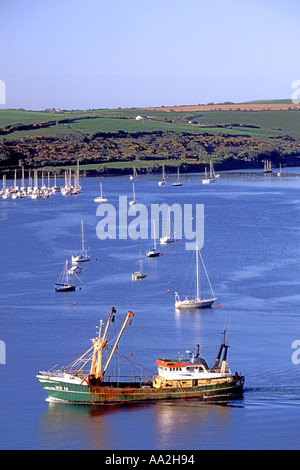 A fishing boat sails out of Kinsale harbour in County Cork, Ireland. Stock Photo