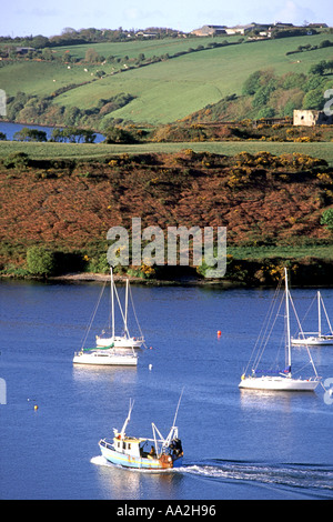 A fishing boat sails out of Kinsale harbour in County Cork, Ireland Stock Photo