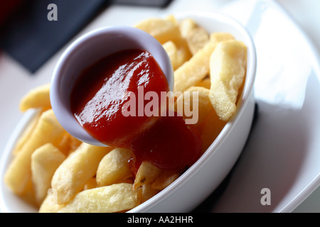 Bowl of chips with tomato ketchup sauce Stock Photo