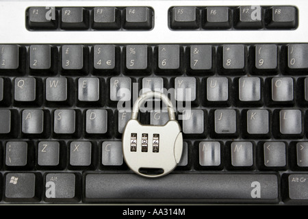 A combination lock on a keyboard representing Internet security. Stock Photo