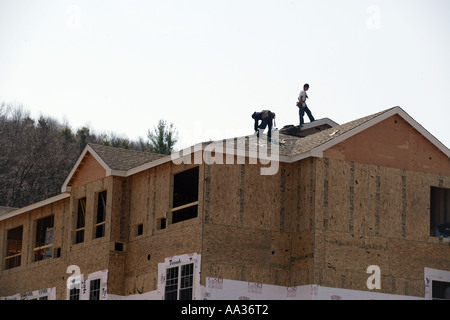 Roofers working on a new Condominium complex in New England Connecticut USA Stock Photo