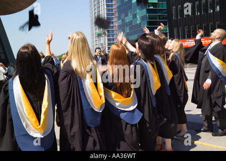 happy students throwing graduation caps in the Air Stock Photo - Alamy