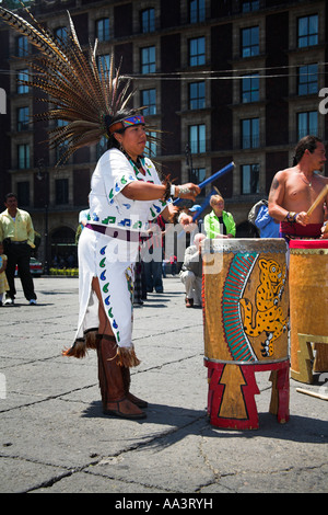 Female Mexican Indian in traditional costume and headdress, banging drum, Zocalo, Plaza de la Constitucion, Mexico City, Mexico Stock Photo
