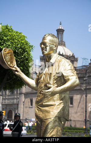 Gold painted street mime artist, Zocalo, Plaza de la Constitucion, Mexico City, Mexico Stock Photo