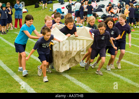 Children running in a sack relay race at primary school sports day in Hobart Tasmania Australia Stock Photo