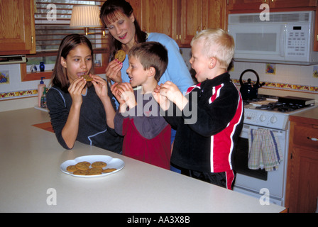 Family in kitchen baking cookies Minnesota Stock Photo