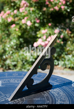 A, ornate, metal garden sundial showing the time on a sunny summer's day Stock Photo