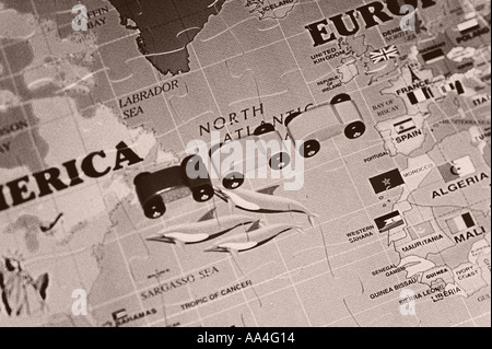 Wooden cars onn large world map puzzle Stock Photo