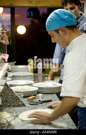 Pizza chef demonstrating art of making pizza dough on marble counter Taormina Sicily Italy Stock Photo