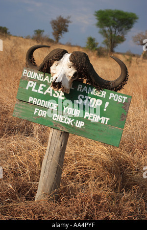 A stop sign demands that tourists produce a permit at a check point in Tarangire National Park in Tanzania East Africa Stock Photo