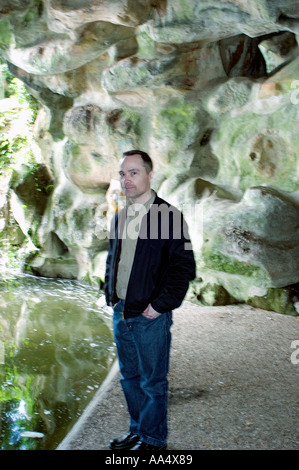 Portrait Mid Adult Man Standing in Cave Single People Outdoors confident adult caucasian looking at camera one person, Paris,, Blue Jeans Stock Photo