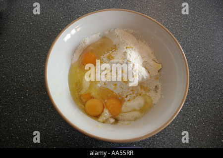 Eggs butter and flour in a mixing bowl. Stock Photo