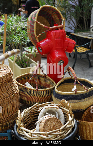 red fire hydrant surrounded by baskets, provence, france Stock Photo