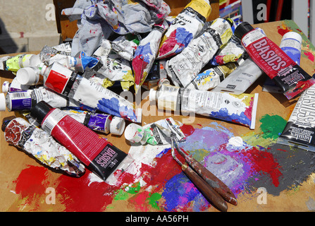 Vibrant multi-coloured artists oil or acrylic paints palette on textured  white paper with paintbrushes Stock Photo - Alamy