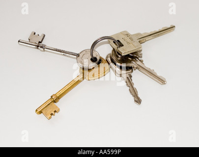 Bunch of keys on a key ring against a plain background Stock Photo