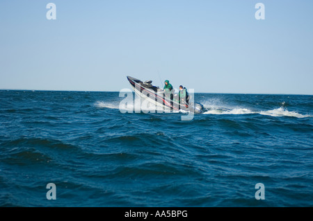 TWO FISHERMEN HEAD OUT OVER BIG WAVES IN A LUND FISHING BOAT ON LAKE MILLE LACS NORTH CENTRAL MINNESOTA Stock Photo