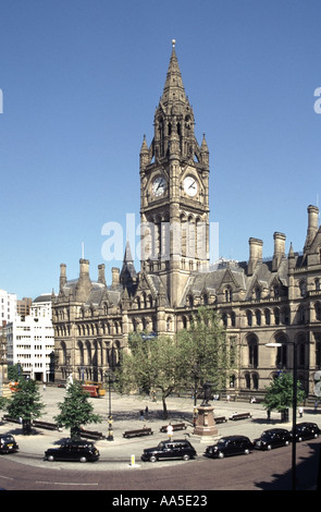 The Town Hall and Clock Tower with taxis in Albert Square in The metropolitan borough of Manchester England UK Stock Photo