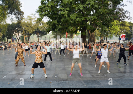 Hanoi, Vietnam. Aerobics class in a public square, Hoan Kiem Lake in background Stock Photo