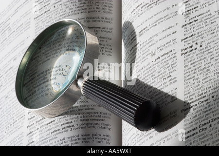 Open book and magnifier on a white background Stock Photo - Alamy