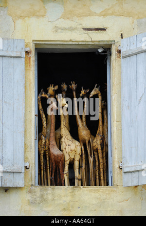 wooden giraffes standing in shop window, france Stock Photo